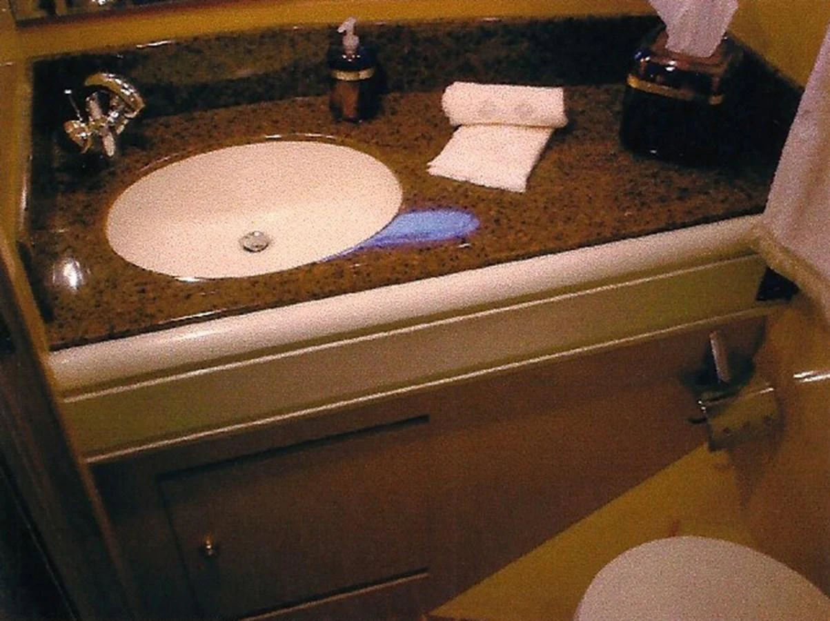 A well-appointed bathroom with a granite countertop and modern fixtures. aboard SHOW ME THE MONEY Yacht for Sale
