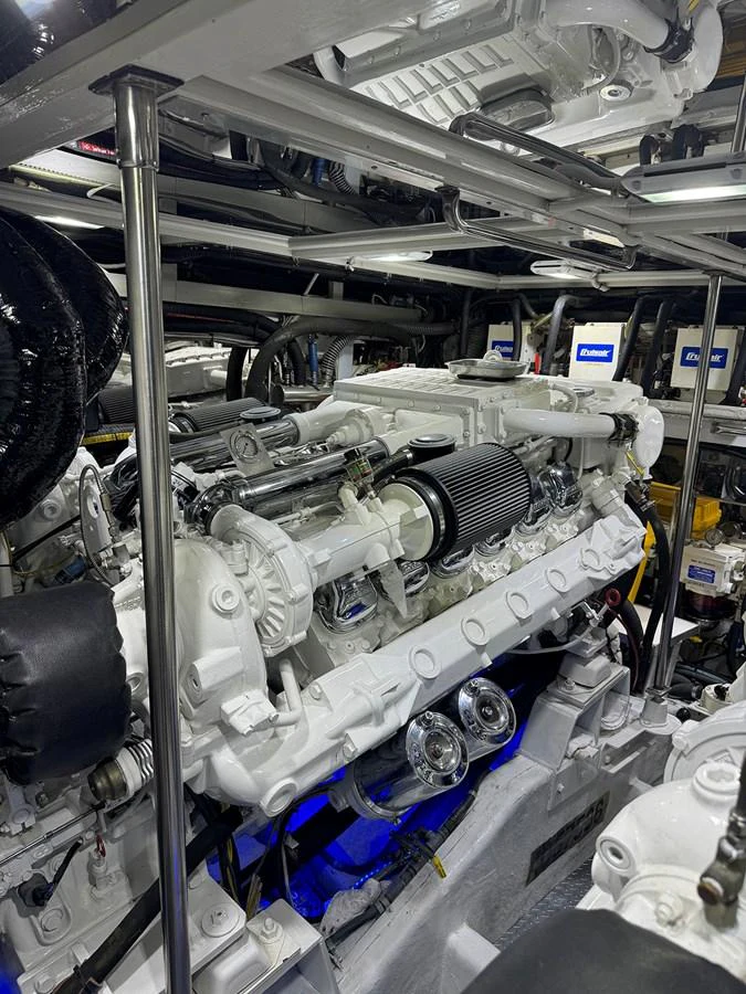 The image showcases the meticulously maintained engine room of the yacht, highlighting powerful machinery and clean engineering. aboard SHOW ME THE MONEY Yacht for Sale