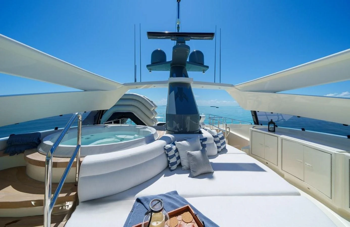 The sundeck features a luxurious jacuzzi and comfortable lounging area with stunning ocean views. aboard BLACK SHEEP Yacht for Sale