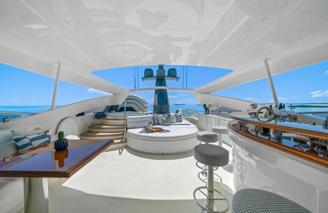 The flybridge offers a luxurious open-air space with comfortable seating and panoramic ocean views. aboard BLACK SHEEP Yacht for Sale