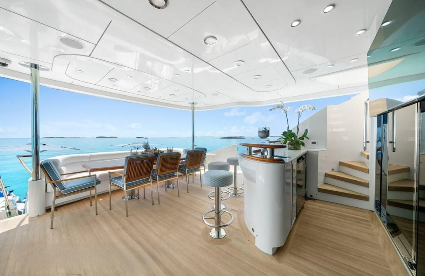 The aft deck offers a luxurious dining and bar area with stunning ocean views. aboard BLACK SHEEP Yacht for Sale