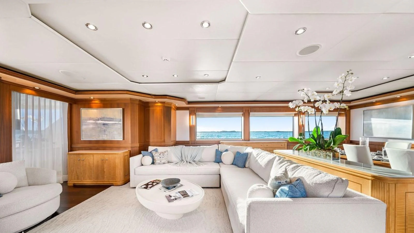 The salon features elegant seating with panoramic ocean views and sophisticated decor. aboard BLACK SHEEP Yacht for Sale