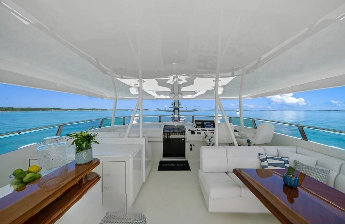 The flybridge offers a spacious and luxurious area with comfortable seating and stunning ocean views. aboard BLACK SHEEP Yacht for Sale