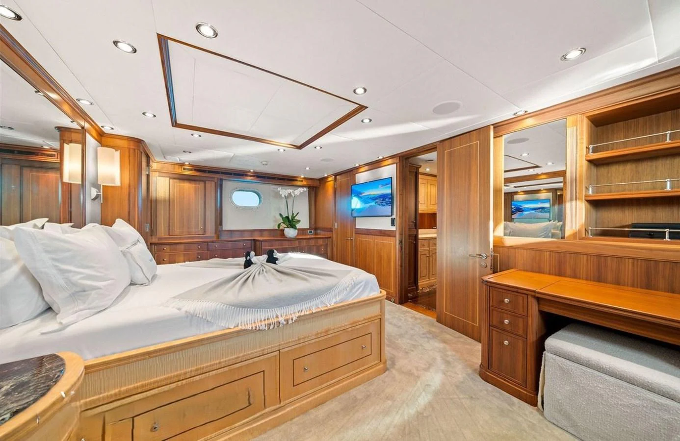 The master stateroom features luxurious wood finishes, a spacious bed, and modern amenities for ultimate comfort. aboard BLACK SHEEP Yacht for Sale