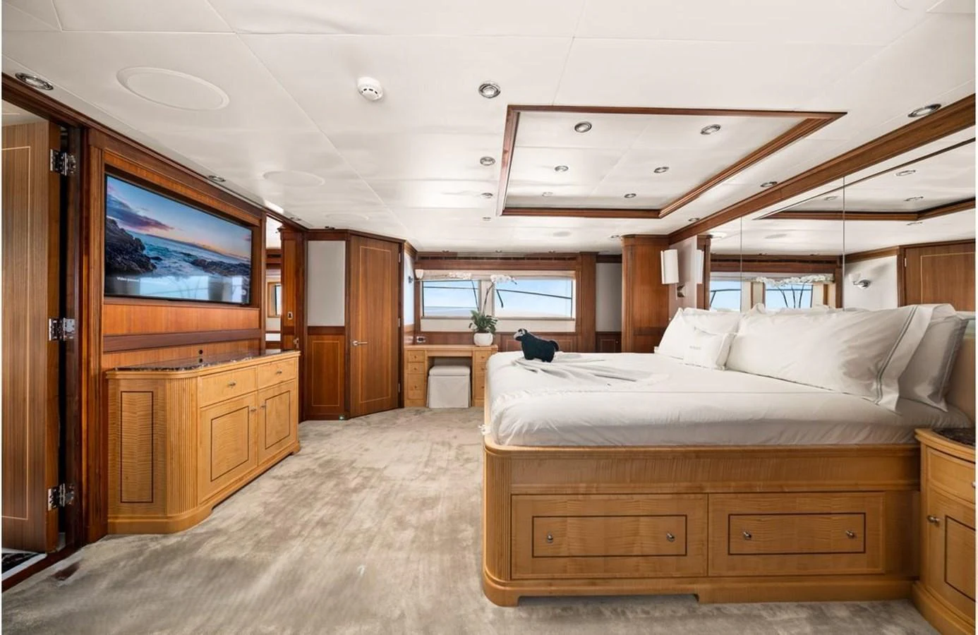 The master stateroom features a spacious layout with luxurious wood finishes and a large bed. aboard BLACK SHEEP Yacht for Sale