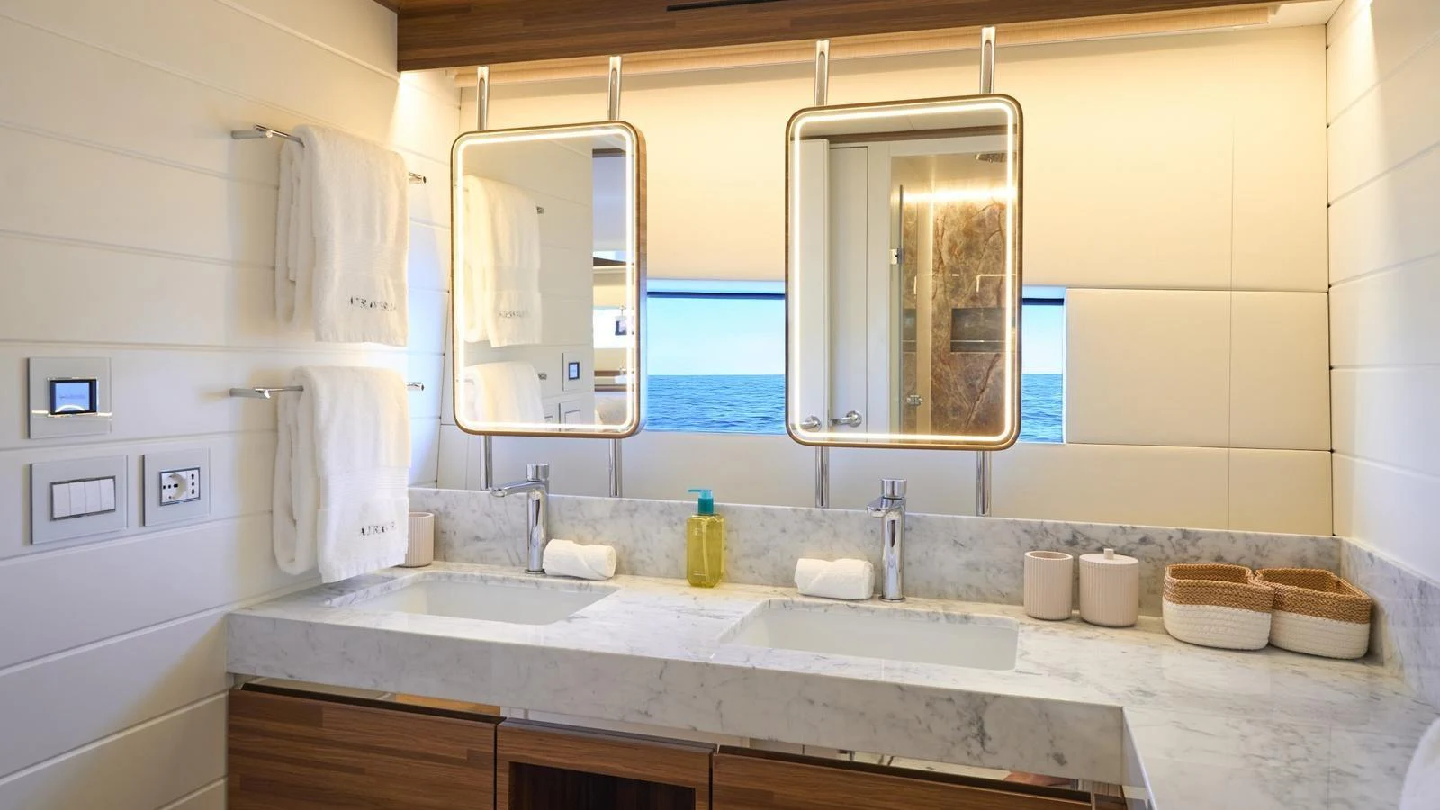 The yacht's bathroom features a luxurious double vanity with marble countertops and modern fixtures. aboard ATRAVERSIA Yacht for Sale