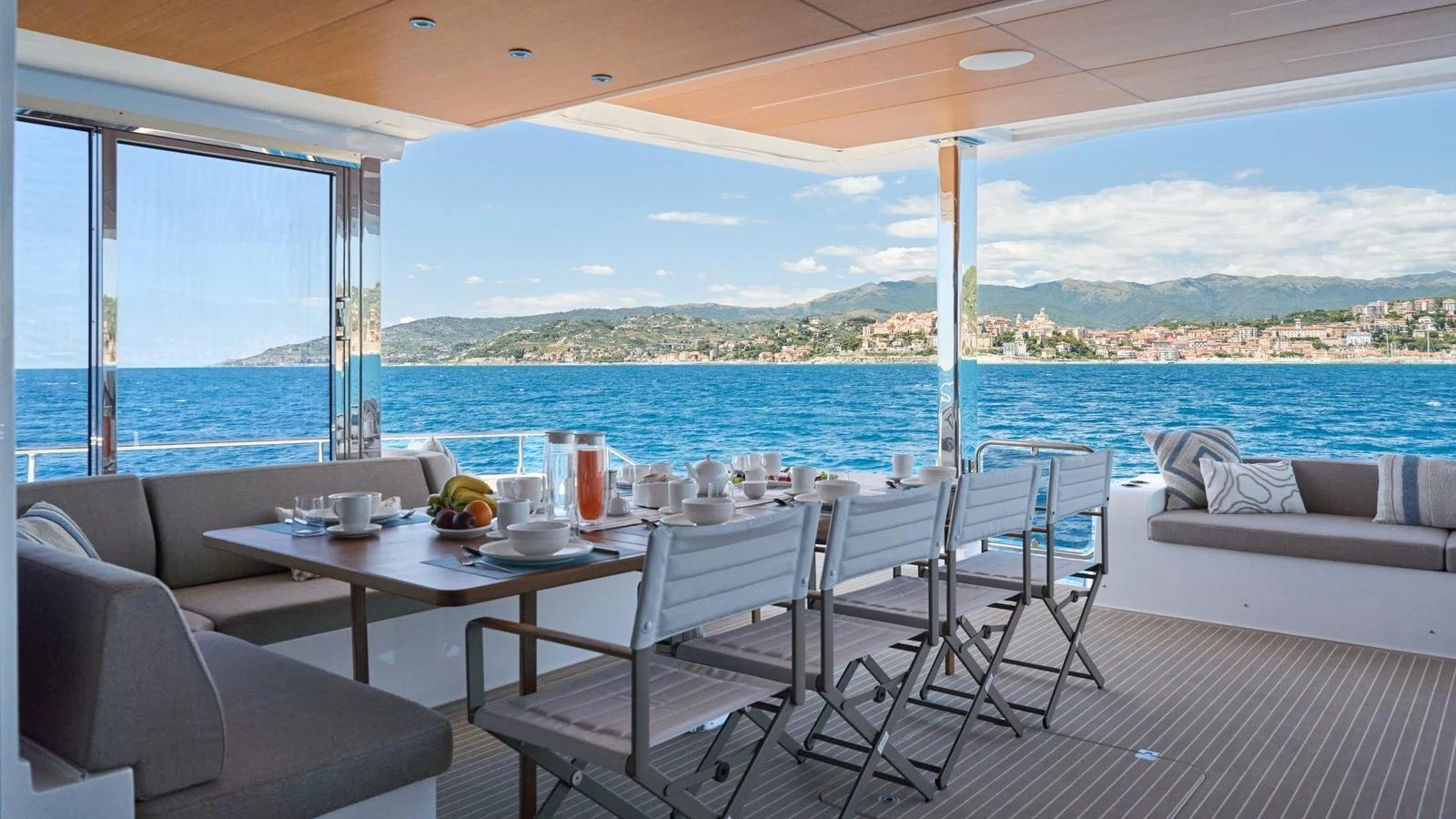 The aft deck offers a spacious and inviting area for alfresco dining with stunning views of the coastline. aboard ATRAVERSIA Yacht for Sale