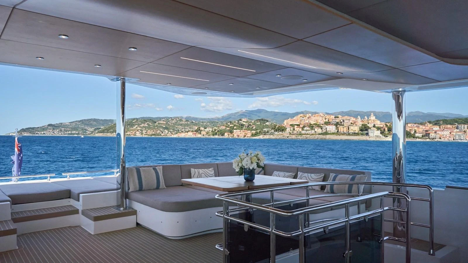 The aft deck offers a spacious and inviting area with comfortable seating and stunning views of the coastline. aboard ATRAVERSIA Yacht for Sale