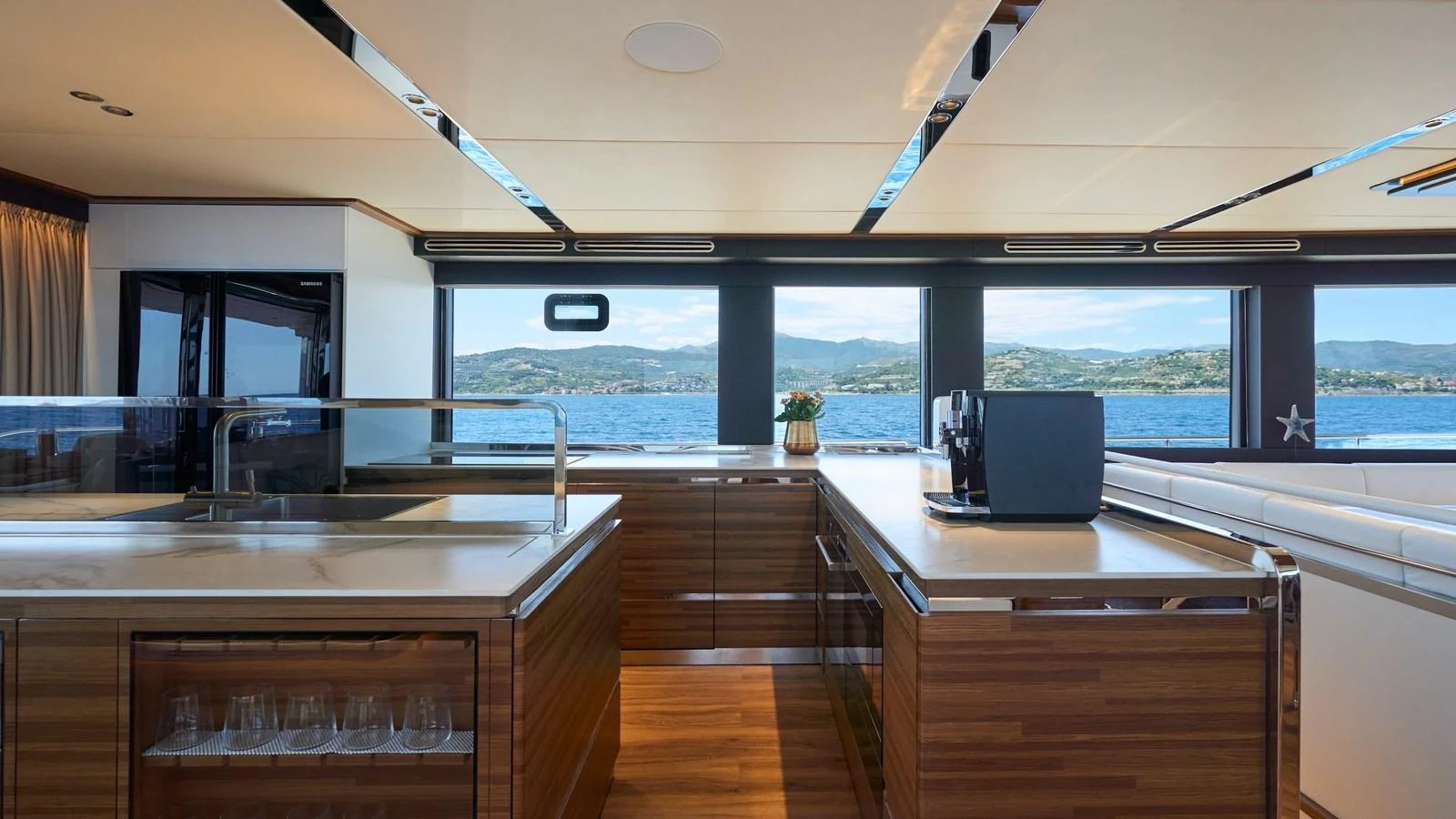 The galley features modern appliances and a panoramic view of the sea. aboard ATRAVERSIA Yacht for Sale