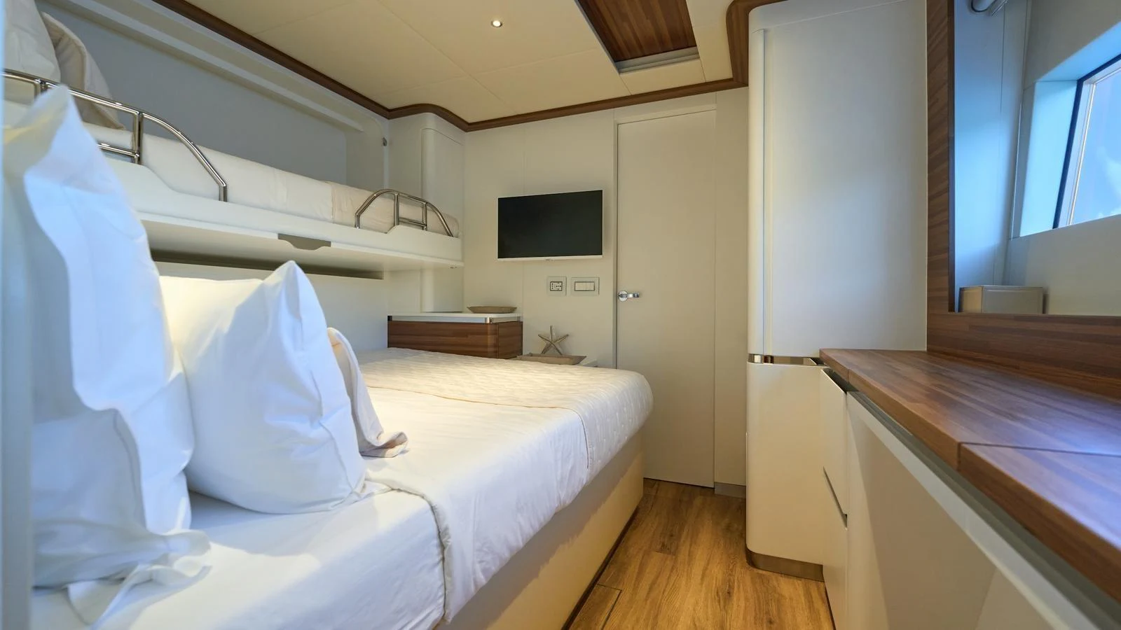A cozy guest stateroom with modern furnishings and a serene atmosphere. aboard ATRAVERSIA Yacht for Sale