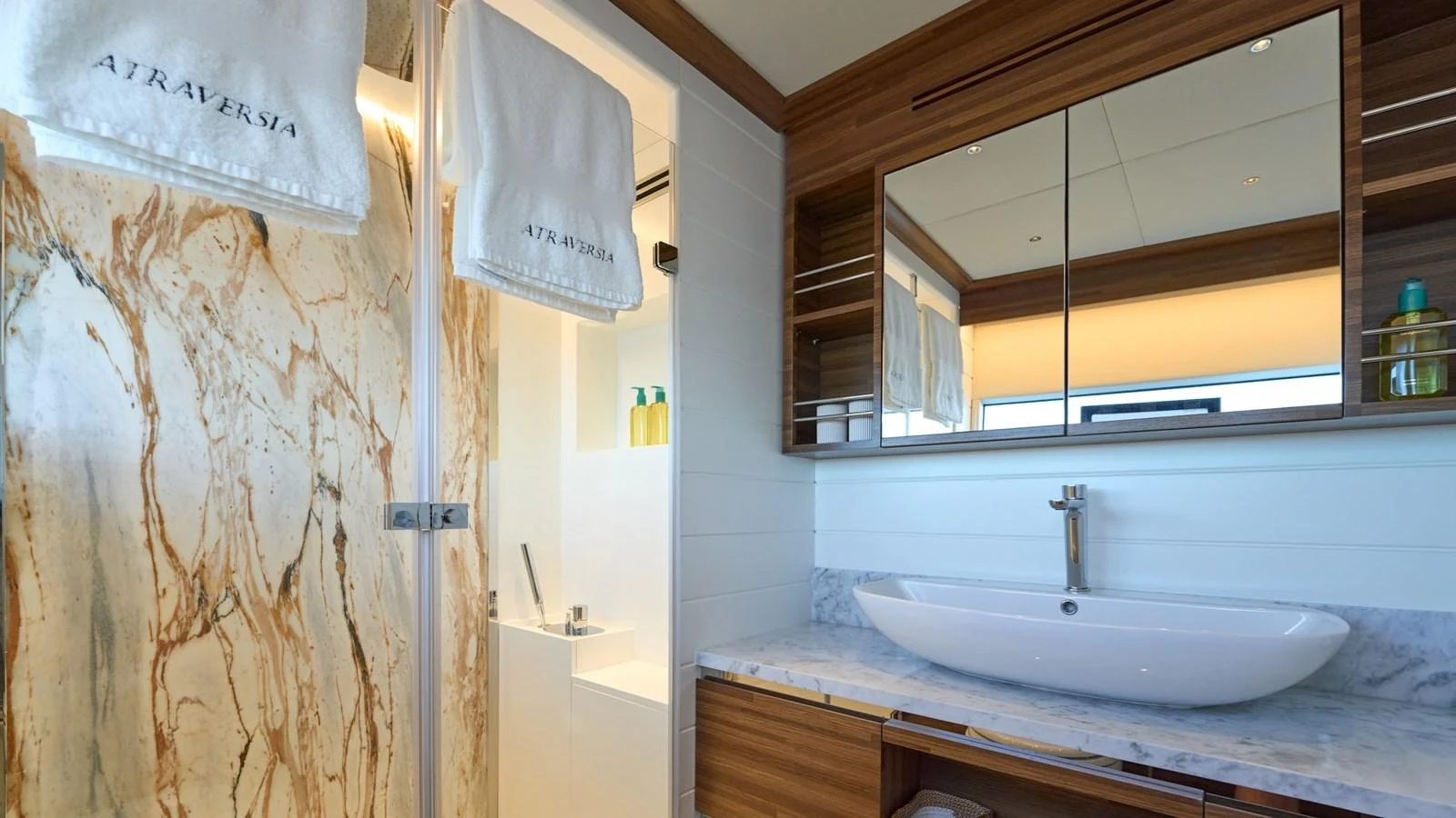 A luxurious bathroom with a marble shower and modern fixtures. aboard ATRAVERSIA Yacht for Sale