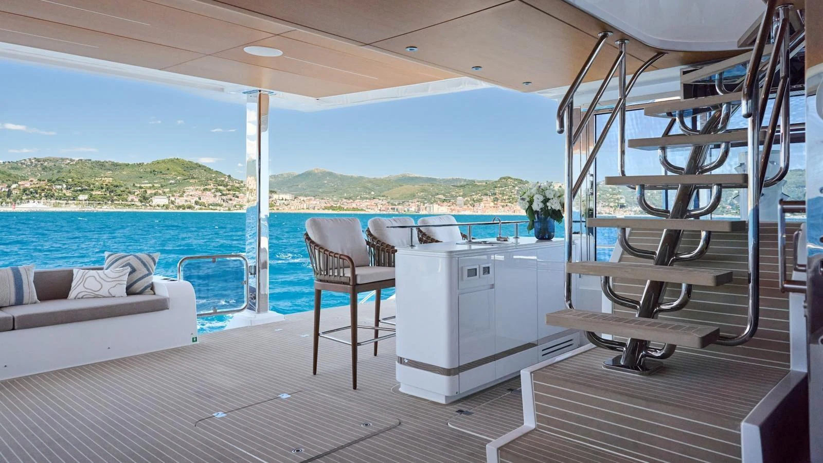 The aft deck offers a luxurious space with comfortable seating and a stunning view of the surrounding waters. aboard ATRAVERSIA Yacht for Sale