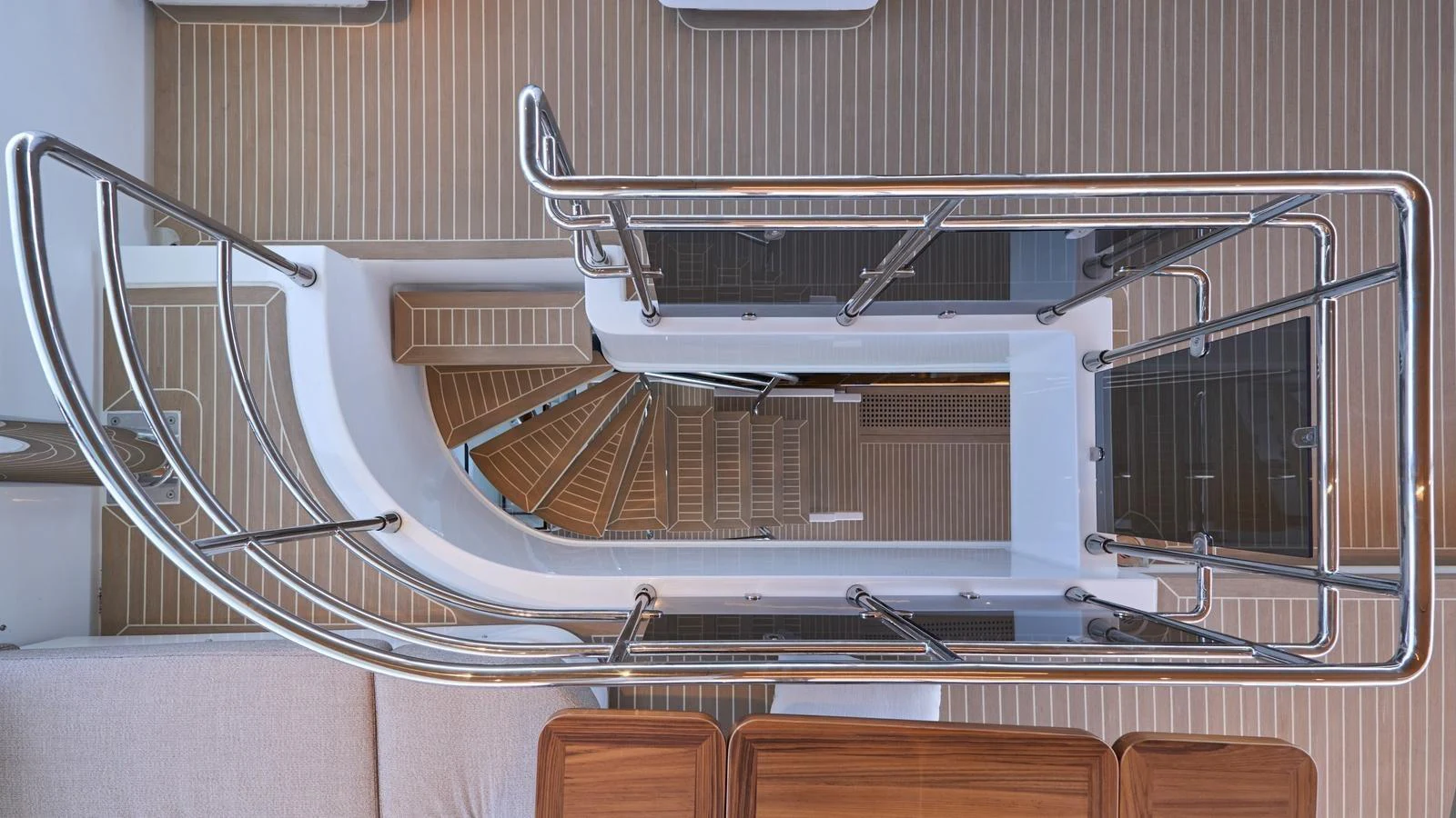 A top-down view of the yacht's staircase showcases its sleek design and craftsmanship. aboard ATRAVERSIA Yacht for Sale