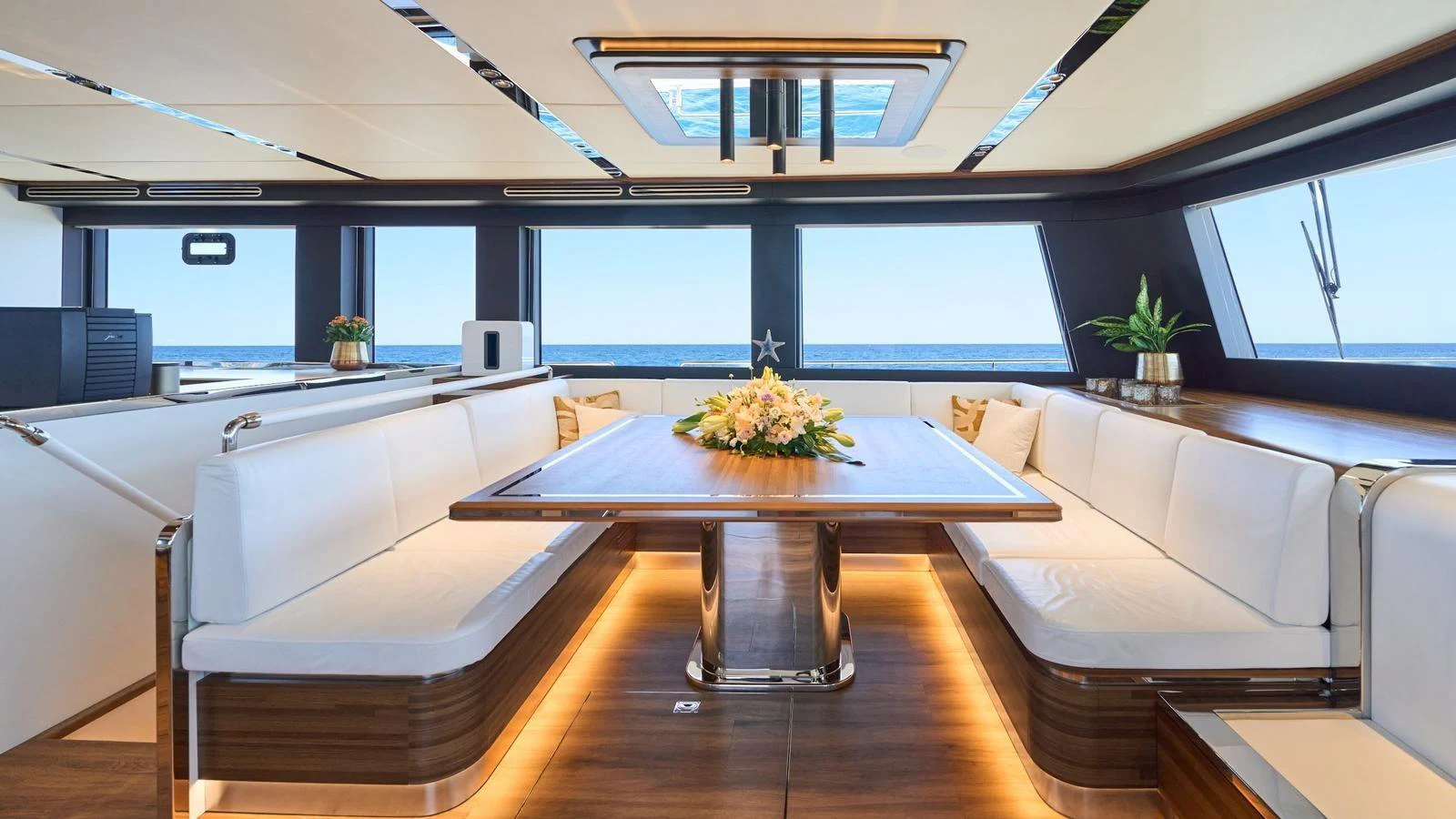 The salon features a spacious dining area with panoramic sea views and elegant decor. aboard ATRAVERSIA Yacht for Sale