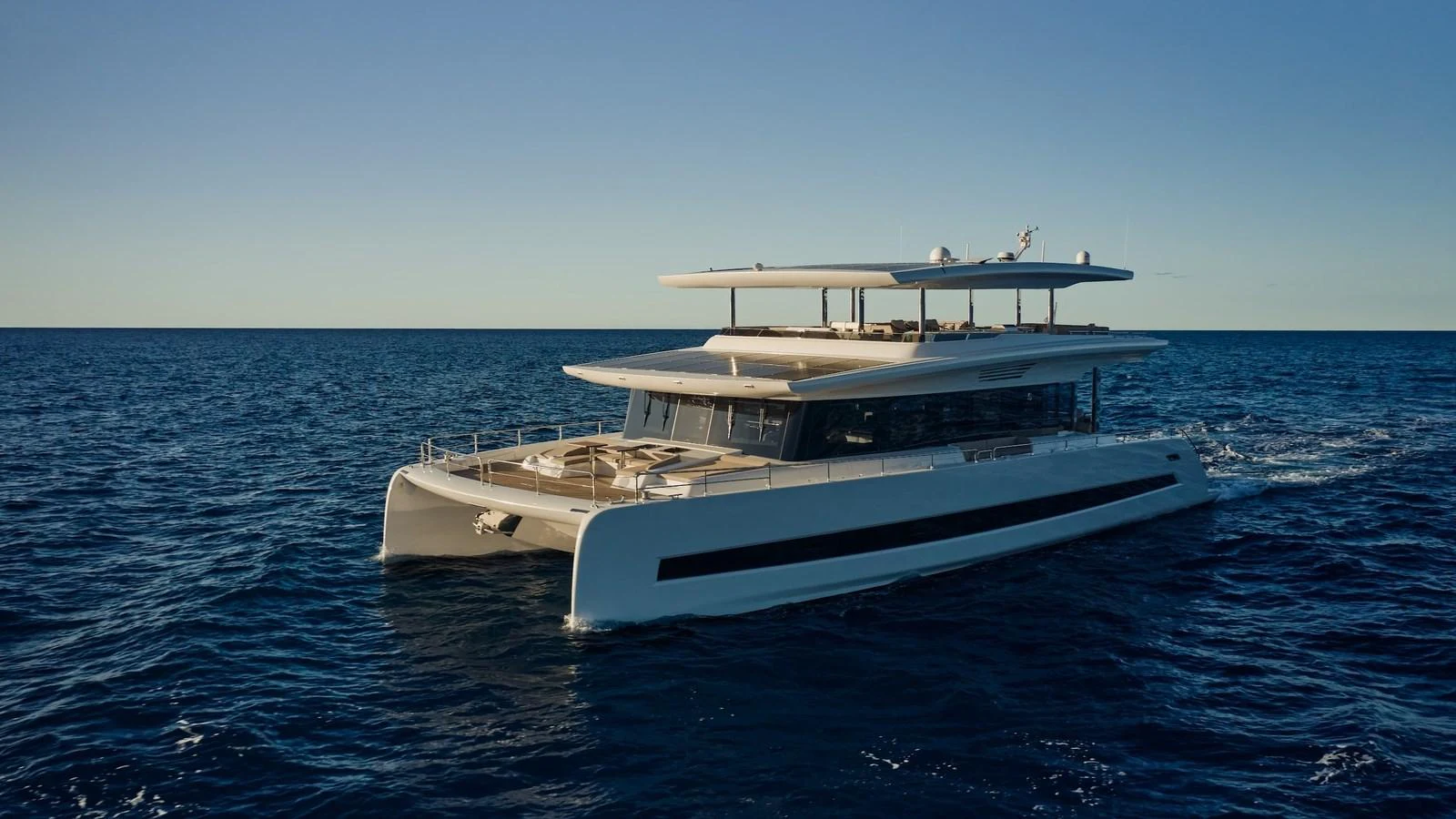 A sleek and modern yacht glides effortlessly over the calm blue waters. aboard ATRAVERSIA Yacht for Sale