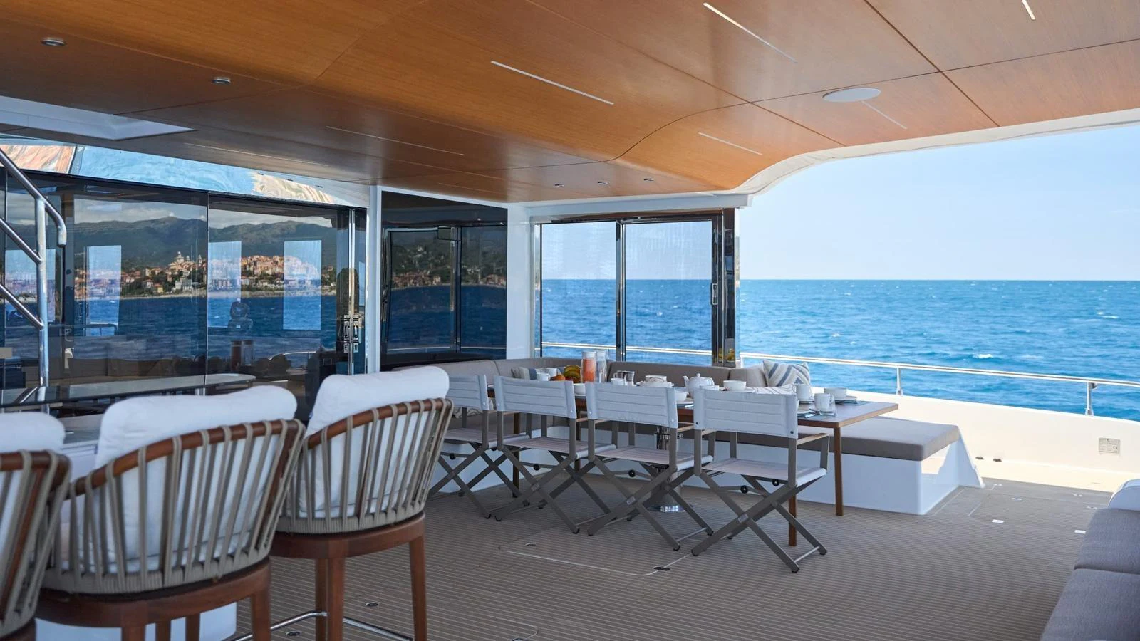 The aft deck offers a spacious and inviting area with comfortable seating and stunning ocean views. aboard ATRAVERSIA Yacht for Sale