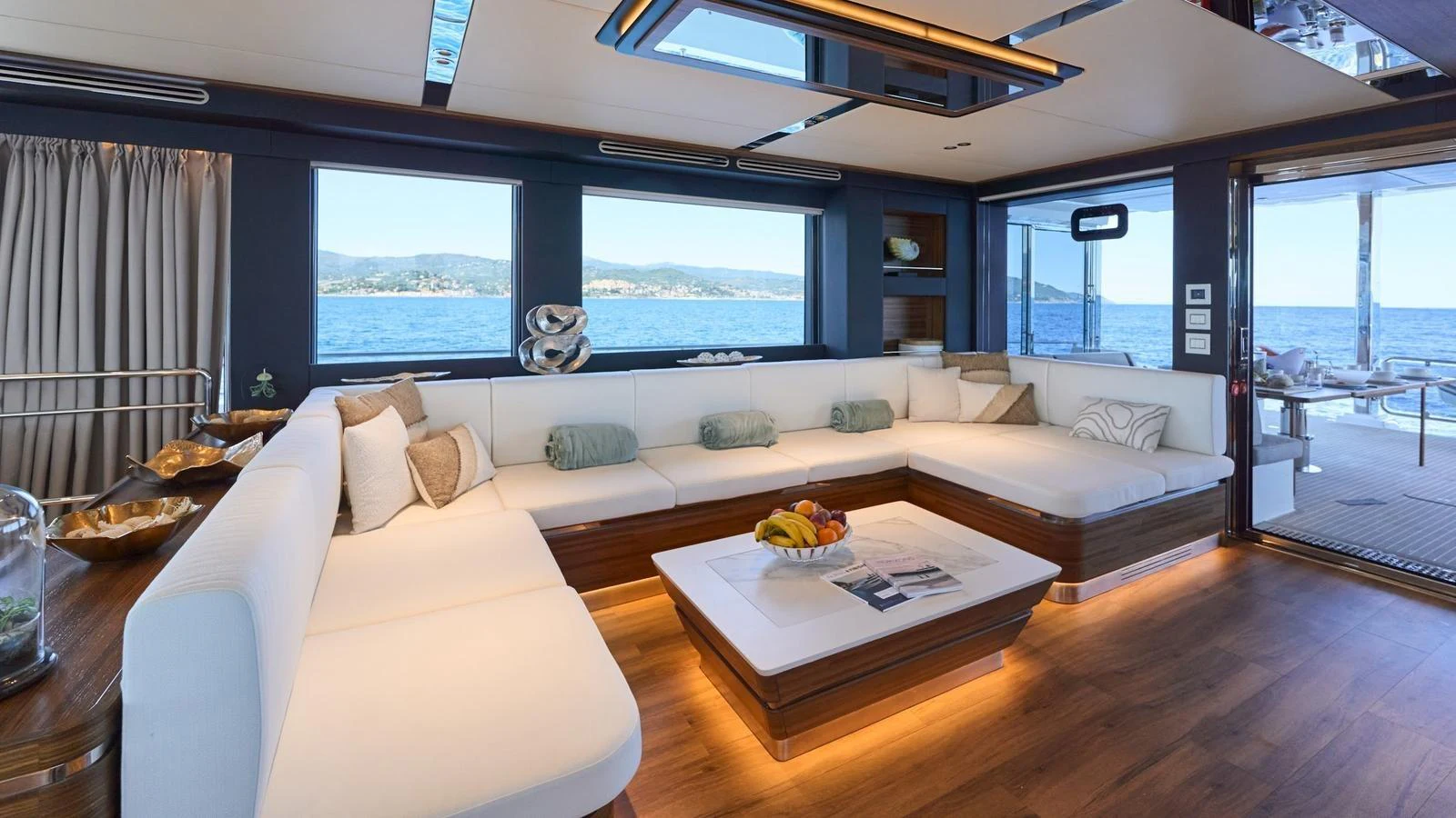 The salon offers a spacious and elegant seating area with panoramic views of the sea. aboard ATRAVERSIA Yacht for Sale