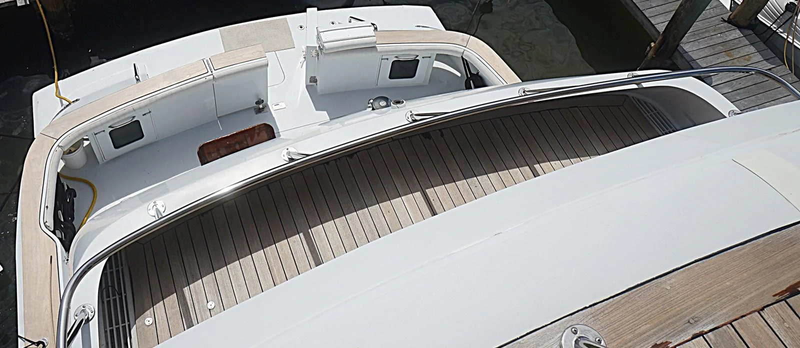 The aft deck of the yacht features a spacious and clean layout with ample seating and a sleek design. aboard HATTERAS 92' Yacht for Sale