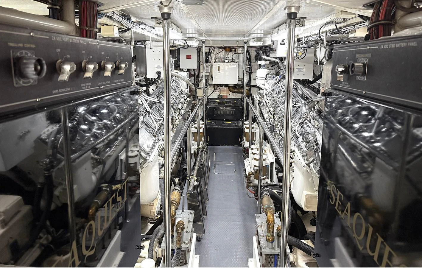 A meticulously organized engine room showcasing powerful machinery and advanced systems. aboard HATTERAS 92' Yacht for Sale