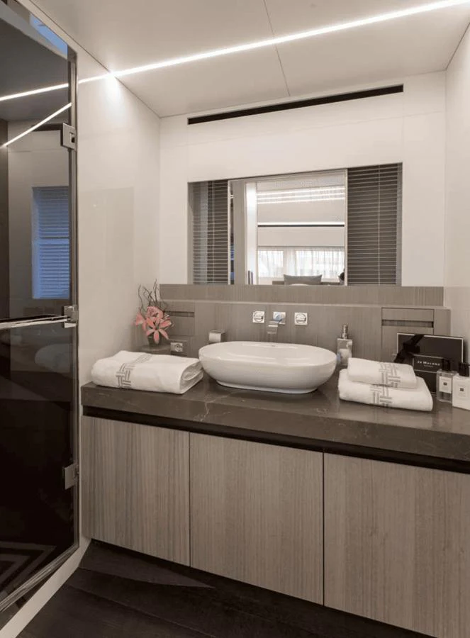 The bathroom features a modern design with a sleek sink and luxurious amenities. aboard MANDAYACHT S07 SPIDER Yacht for Sale