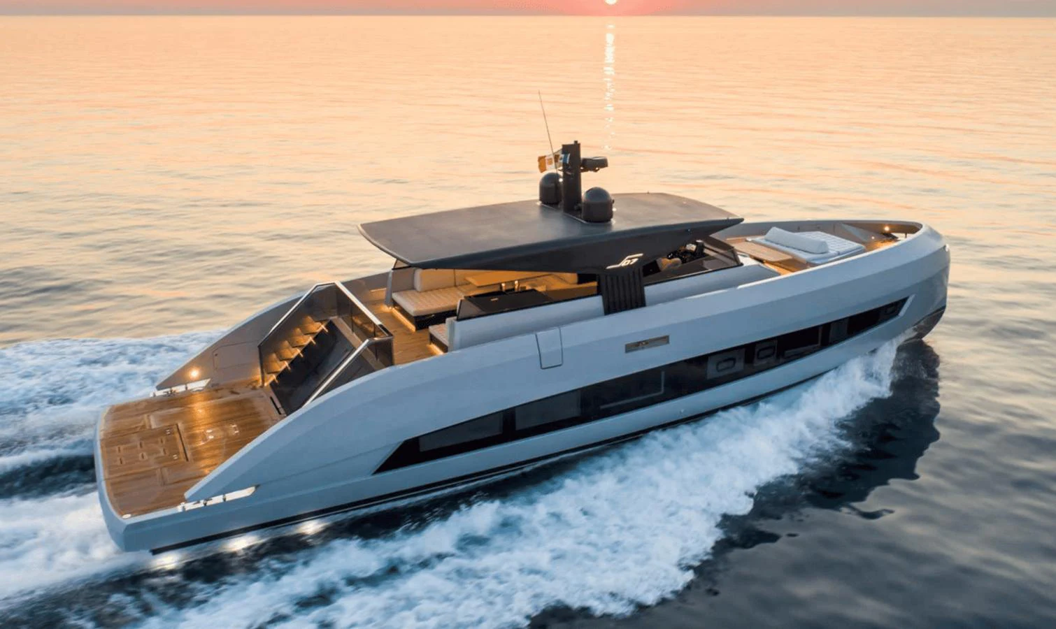 A sleek, modern yacht cruises smoothly on calm waters at sunset. aboard MANDAYACHT S07 SPIDER Yacht for Sale
