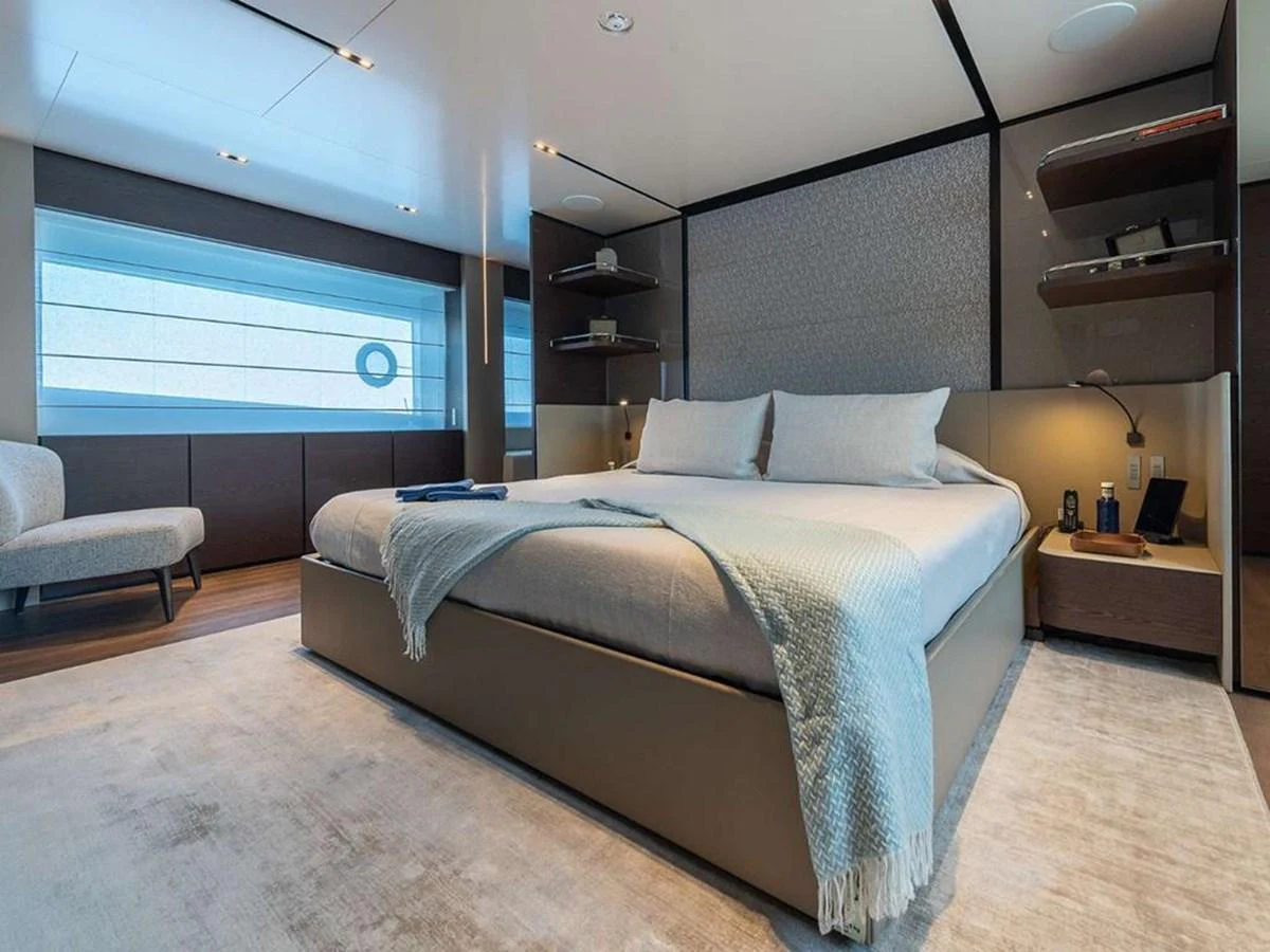 The master stateroom features a spacious bed with modern decor and ample natural light. aboard ON Yacht for Sale