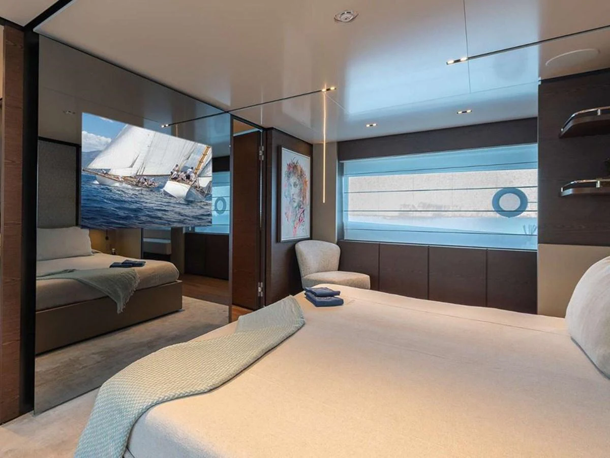 A luxurious stateroom featuring a comfortable bed and modern decor. aboard ON Yacht for Sale