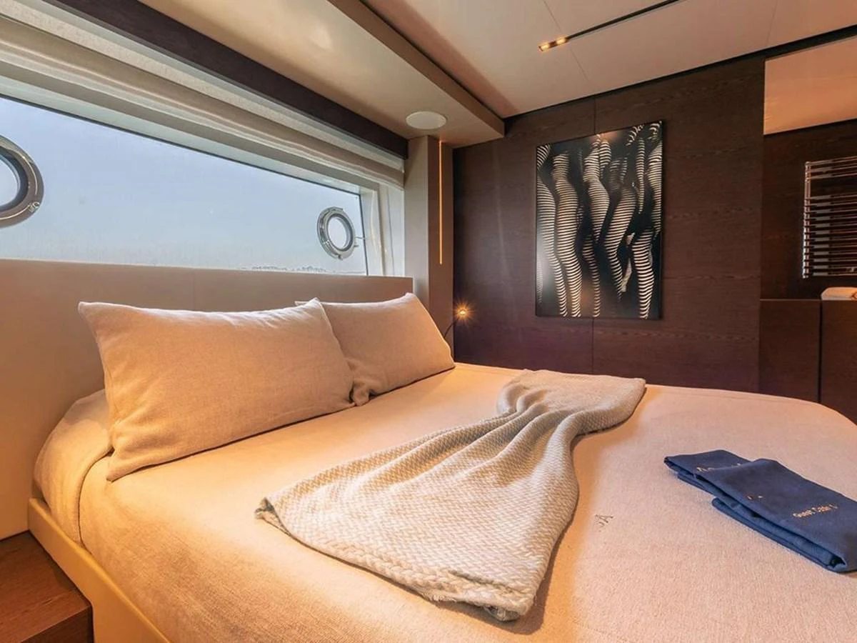 The stateroom features a plush bed with soft linens and modern decor, creating a cozy and inviting atmosphere. aboard ON Yacht for Sale