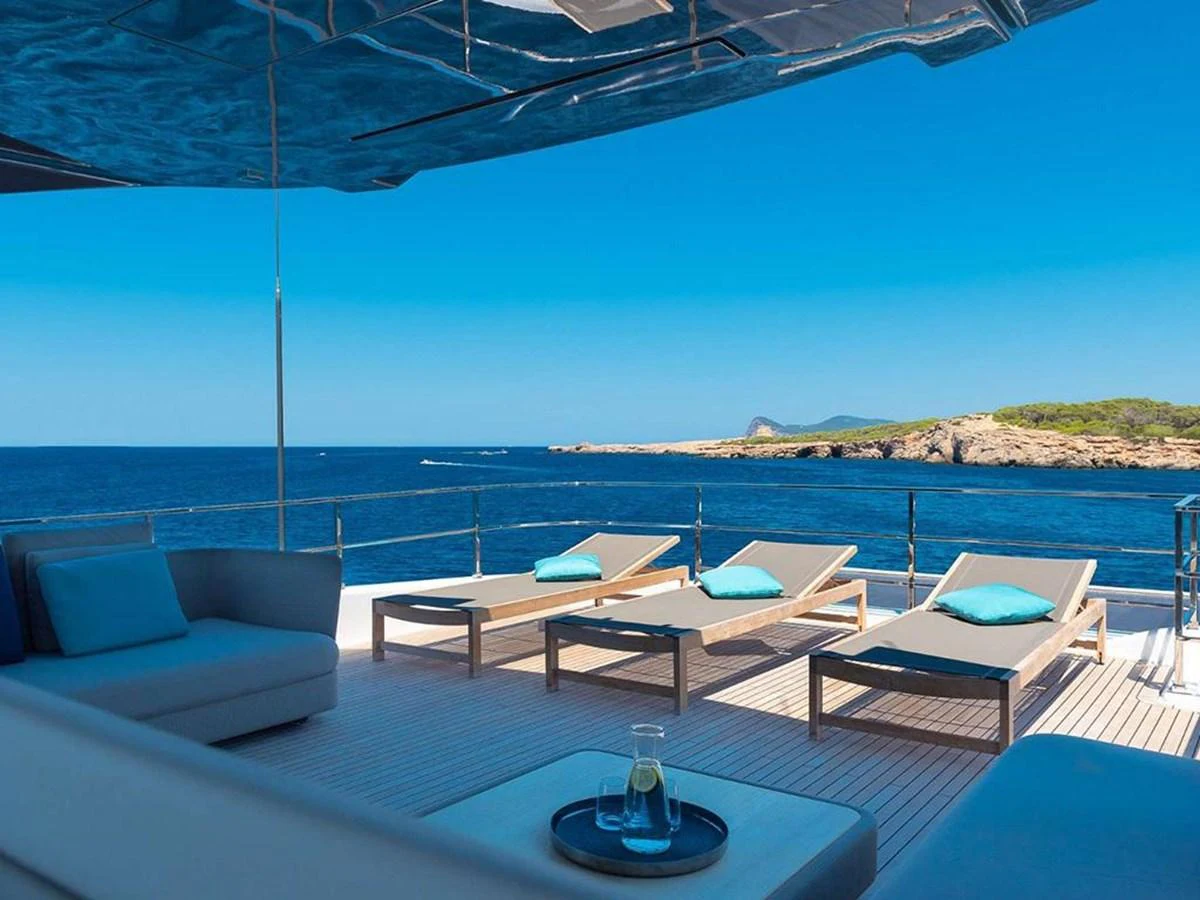 The sundeck offers a serene space with sun loungers and a stunning ocean view. aboard ON Yacht for Sale