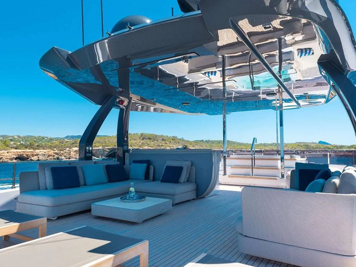 The aft deck features a spacious and stylish lounging area with modern furnishings and a stunning view of the surroundings. aboard ON Yacht for Sale