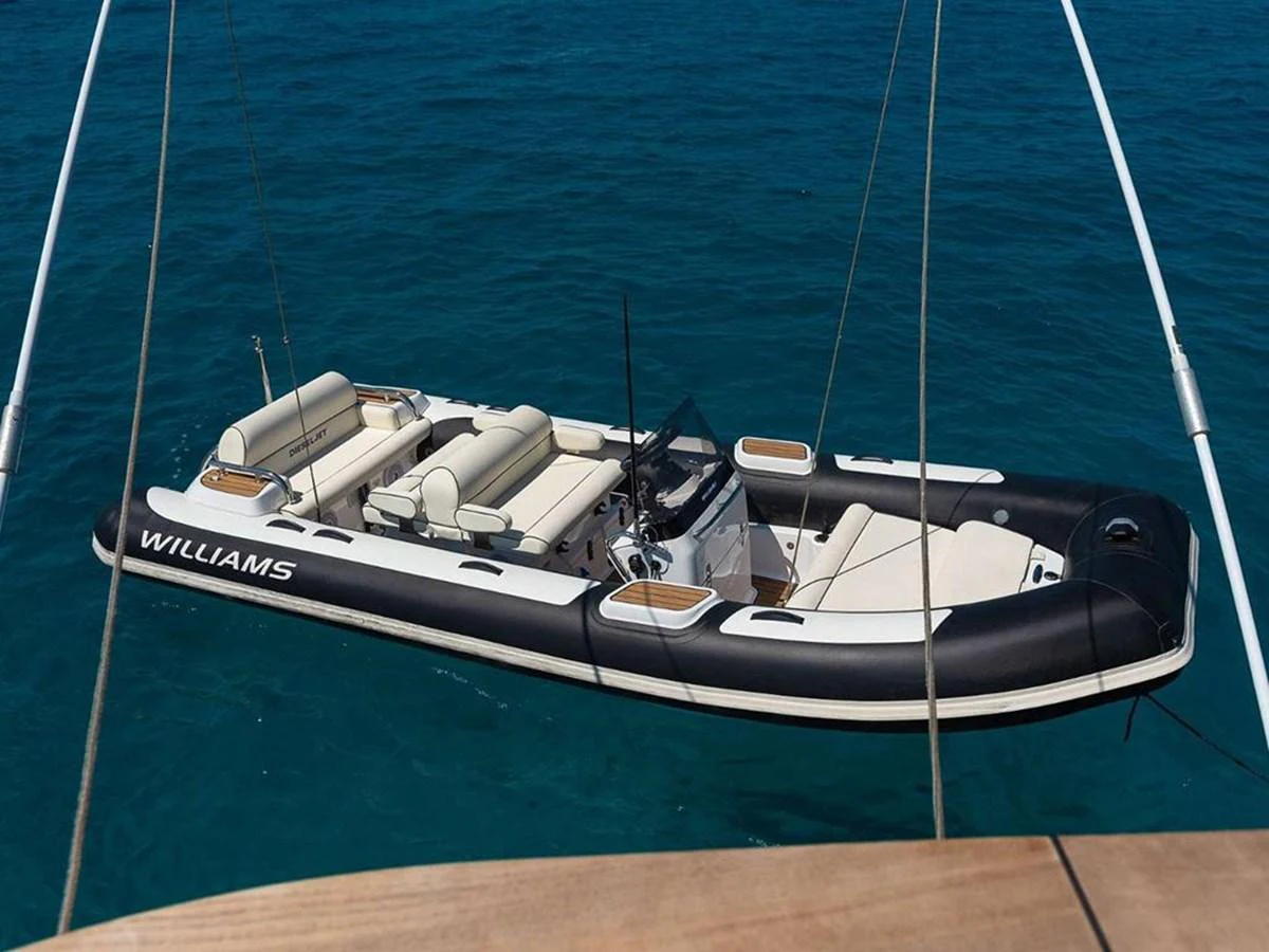 A sleek and spacious tender floats on clear blue waters, ready for excursions. aboard ON Yacht for Sale