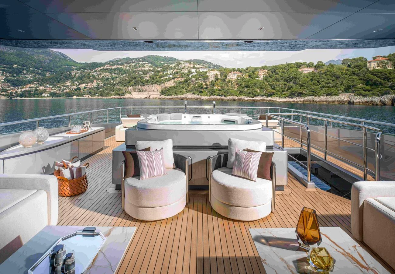 The aft deck features a luxurious jacuzzi with comfortable seating and stunning views. aboard SAIRU Yacht for Sale