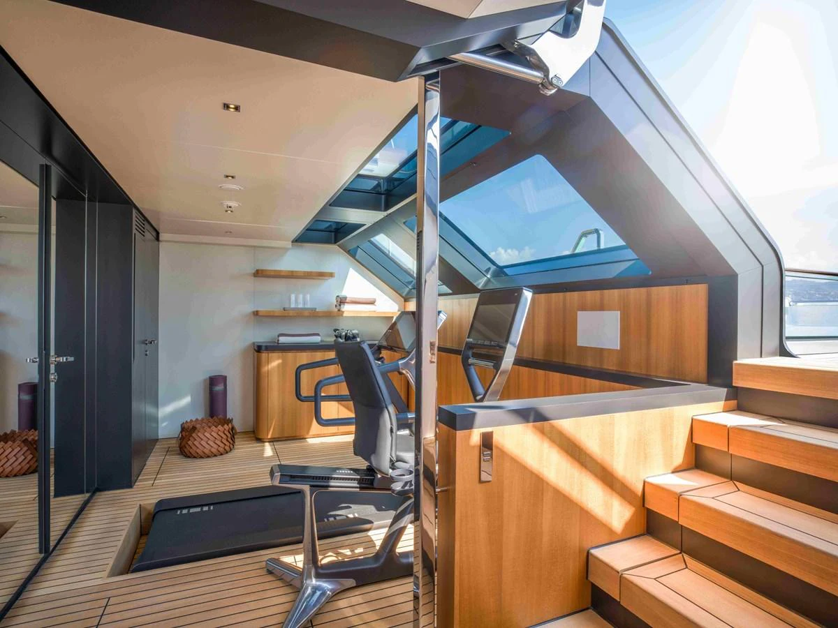 The yacht's gym features modern equipment and ample natural light for an invigorating workout experience. aboard SAIRU Yacht for Sale