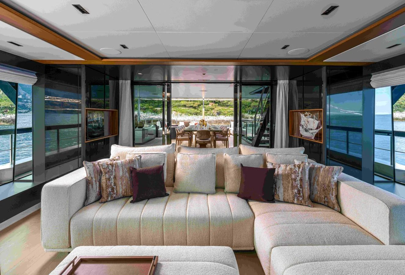 The salon offers a spacious and inviting area with plush seating and panoramic views. aboard SAIRU Yacht for Sale
