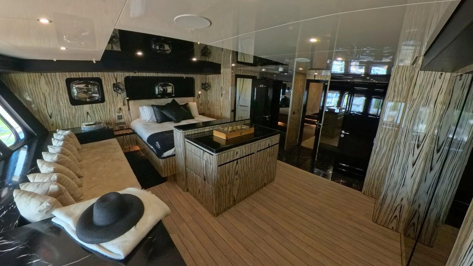 The master stateroom features a luxurious bed, elegant decor, and ample natural light. aboard ODISEA Yacht for Sale
