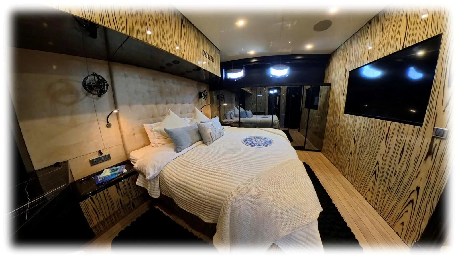 The master stateroom features a luxurious bed with elegant bedding and modern decor. aboard ODISEA Yacht for Sale