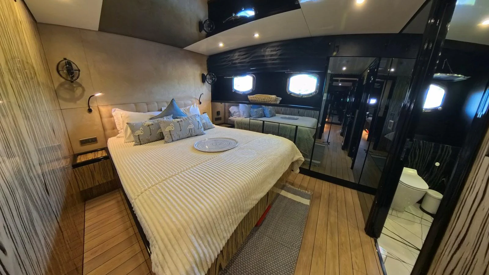 The master stateroom features a spacious bed with elegant decor and ample natural light. aboard ODISEA Yacht for Sale
