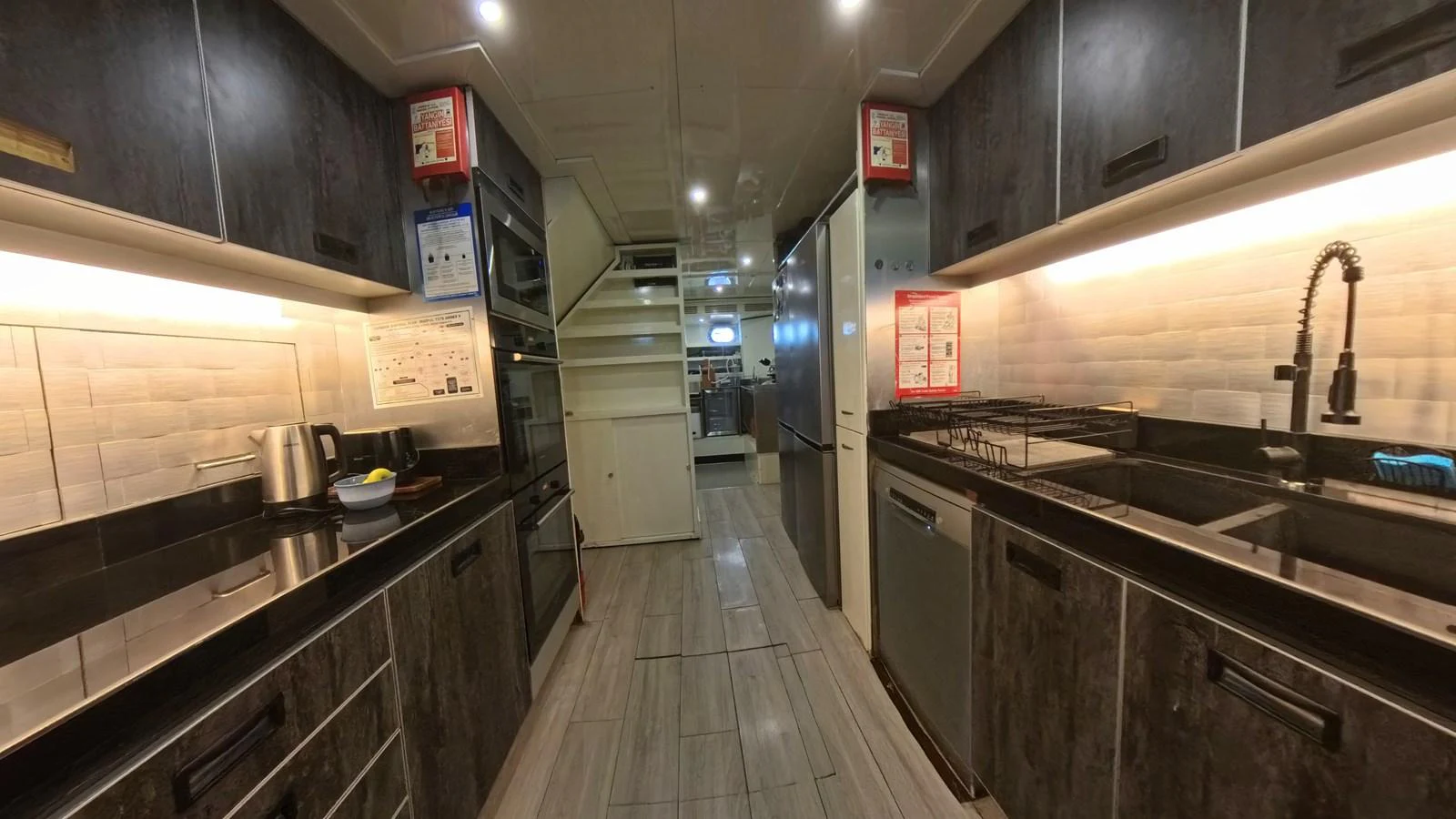The galley is equipped with modern appliances and ample counter space, offering a practical and stylish environment for meal preparation. aboard ODISEA Yacht for Sale
