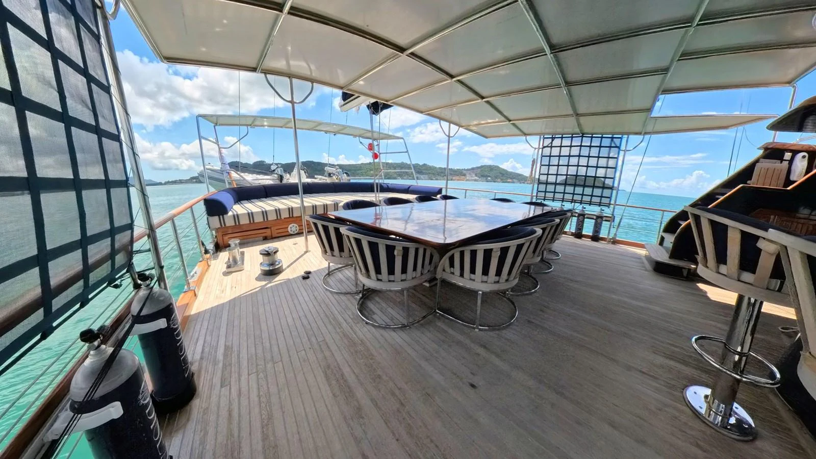 The aft deck offers a spacious and shaded area for outdoor dining and relaxation with stunning sea views. aboard ODISEA Yacht for Sale
