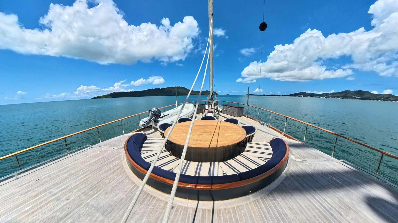 The yacht's foredeck features a spacious circular seating area with stunning ocean views. aboard ODISEA Yacht for Sale