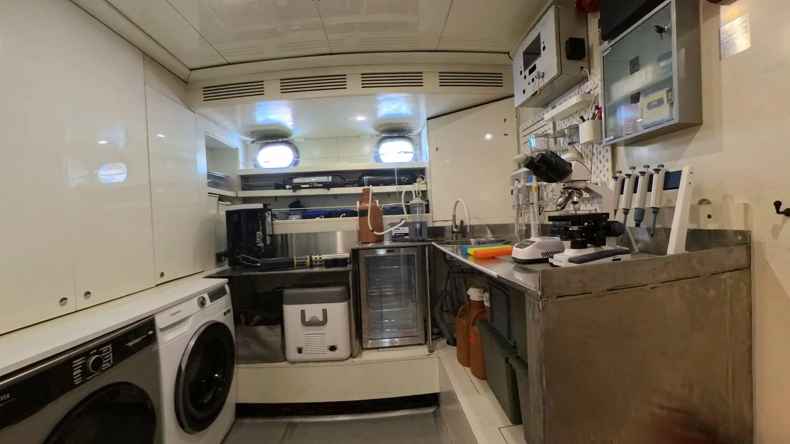 A well-equipped laundry room with modern appliances and ample storage space. aboard ODISEA Yacht for Sale