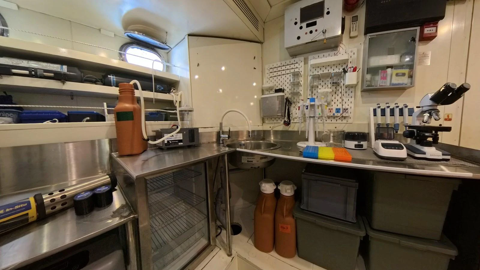 The yacht's galley is equipped with scientific instruments and storage, indicating a specialized purpose. aboard ODISEA Yacht for Sale