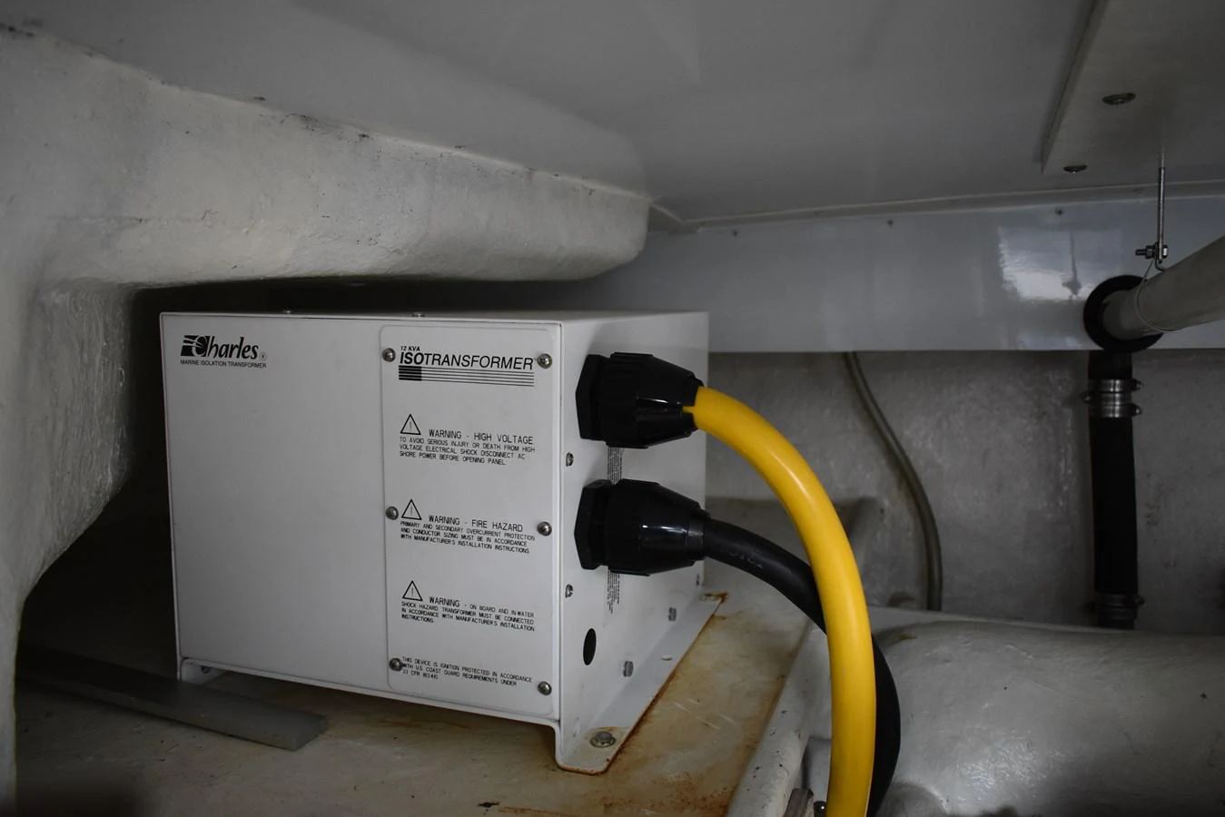 A close-up view of the yacht's electrical transformer in the engine room. aboard 64 OCEAN ALEXANDER Yacht for Sale