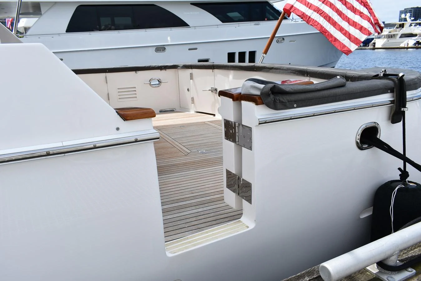 The yacht's aft deck features a clean, open layout with a view of the water and nearby boats. aboard 64 OCEAN ALEXANDER Yacht for Sale