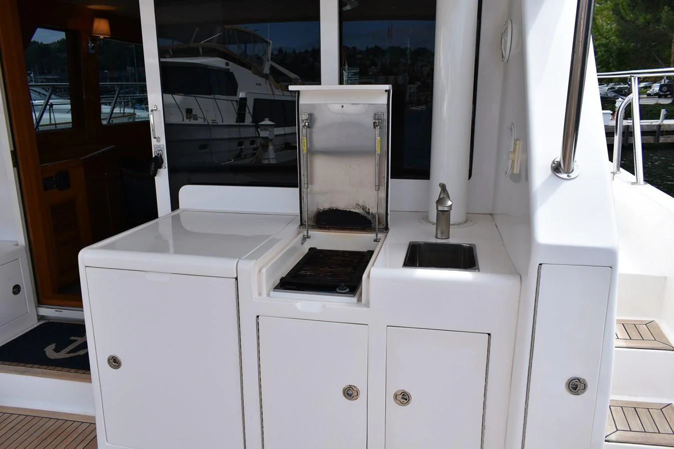 This image showcases a well-equipped outdoor galley area on the yacht, perfect for alfresco dining and entertaining. aboard 64 OCEAN ALEXANDER Yacht for Sale