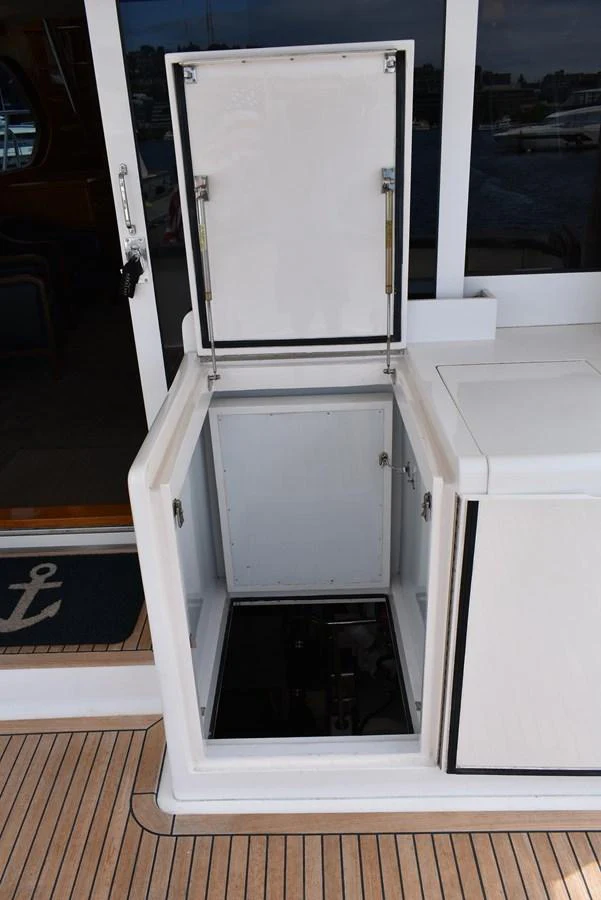 A detailed view of an open storage compartment on the yacht's deck. aboard 64 OCEAN ALEXANDER Yacht for Sale