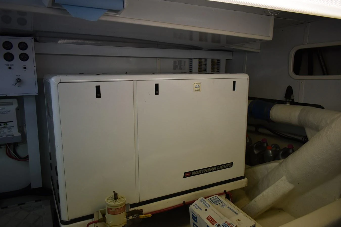 The image shows the engine room with a Northern Lights generator and various equipment. aboard 64 OCEAN ALEXANDER Yacht for Sale