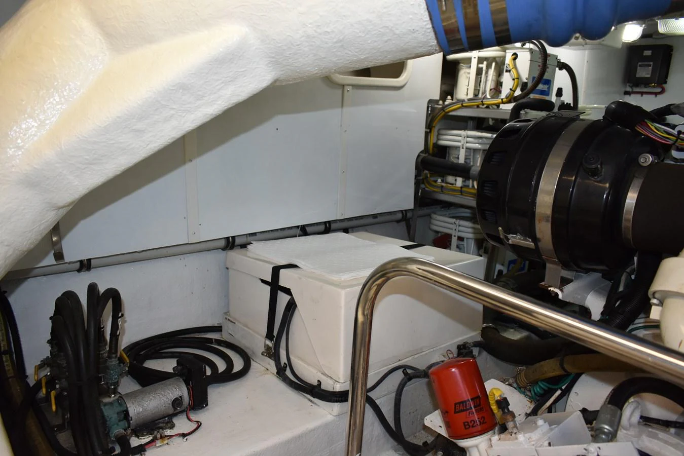 The image showcases the yacht's well-maintained engine room with various mechanical components. aboard 64 OCEAN ALEXANDER Yacht for Sale