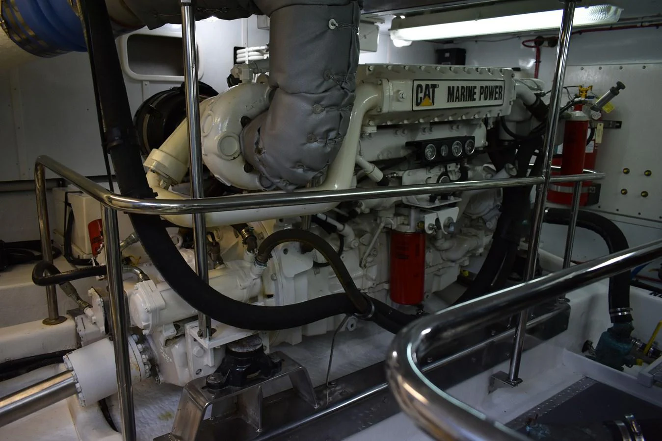 The engine room showcases a powerful marine engine with robust components. aboard 64 OCEAN ALEXANDER Yacht for Sale