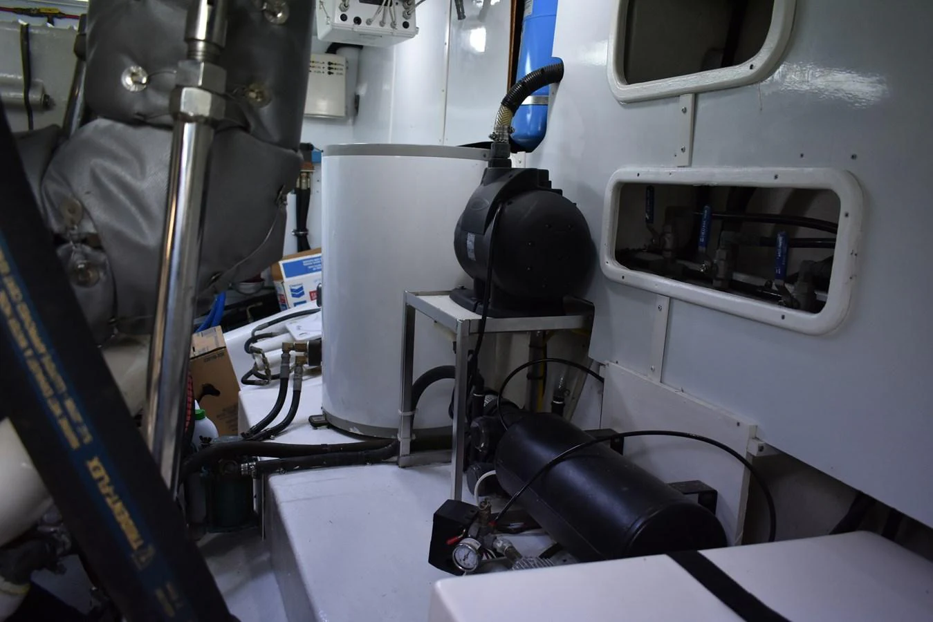 The engine room is equipped with essential machinery and components for yacht operation. aboard 64 OCEAN ALEXANDER Yacht for Sale